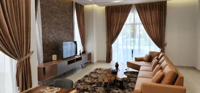 a living room with a couch and a tv at Zinnia Residence Tanah Rata in Cameron Highlands