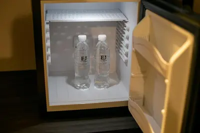 two bottles of water sitting inside of a refrigerator at Eureka Hotel Penang in Bayan Lepas