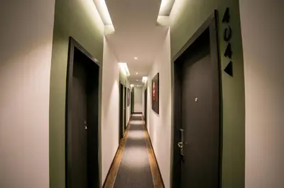 a long hallway with green and white walls at Eureka Hotel Penang in Bayan Lepas