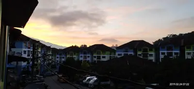 a view of a city with buildings and a sunset at Cameron Highlands Muslim Apartment by AziziCameron in Cameron Highlands