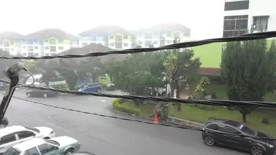 a view of a street with cars parked on the road at Cameron Highlands Muslim Apartment by AziziCameron in Cameron Highlands