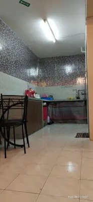 a kitchen with a table and a chair in a room at Cameron Highlands Muslim Apartment by AziziCameron in Cameron Highlands