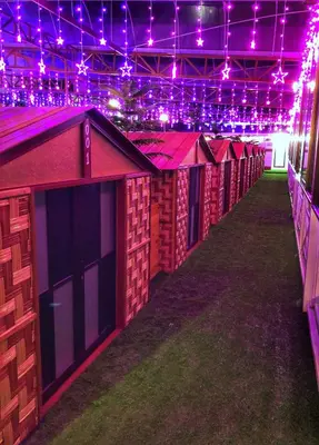 a row of wooden huts in a building with lights at Kea Garden Mini Chalet in Cameron Highlands