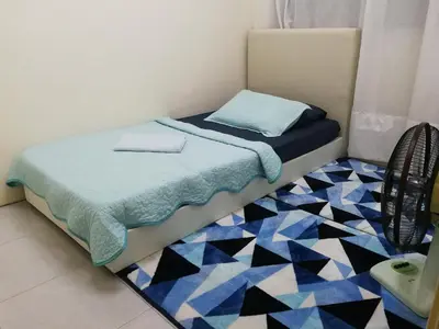 a small bedroom with a bed and a rug at A1-04-03 Damiana Apartment in Tanjung Malim