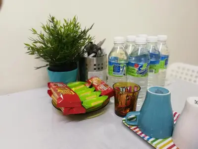 a counter with bottles of water and snacks and drinks at A1-04-03 Damiana Apartment in Tanjung Malim