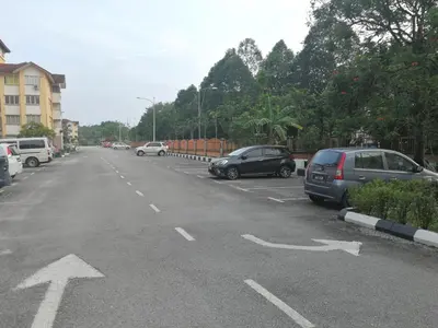 a parking lot with cars parked on the street at A1-04-03 Damiana Apartment in Tanjung Malim