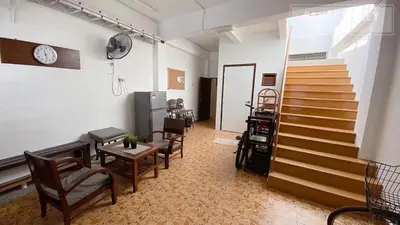 a room with stairs and chairs and a stair case at 24 Kimberley in George Town