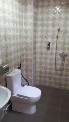 a bathroom with a toilet and a shower and a sink at TULIP HOTEL & APARTMENT in Cameron Highlands