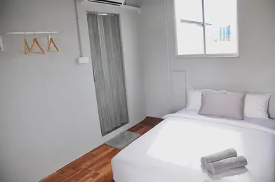 a white bed in a room with a window at GRAYHAUS SOHO Ipoh in Ipoh