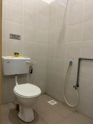 a bathroom with a toilet and a shower at Abg Long Fadhil Homestay in Sungai Petani