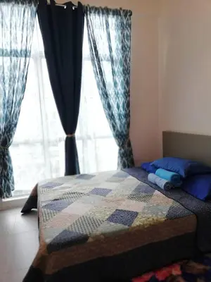 a bedroom with a quilt on a bed with a window at Casa D'One Homestay D Pasar Malam in Cameron Highlands