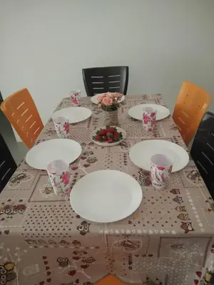 a table with plates and bowls of fruit on it at Casa D'One Homestay D Pasar Malam in Cameron Highlands
