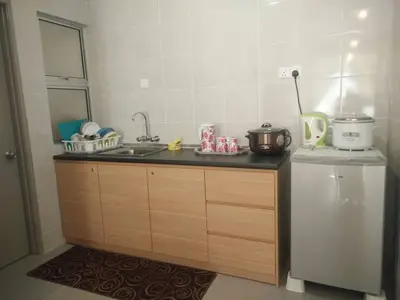 a kitchen with a sink and a refrigerator at Casa D'One Homestay D Pasar Malam in Cameron Highlands