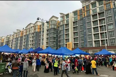 a large crowd of people standing in front of blue tents at Casa D'One Homestay D Pasar Malam in Cameron Highlands