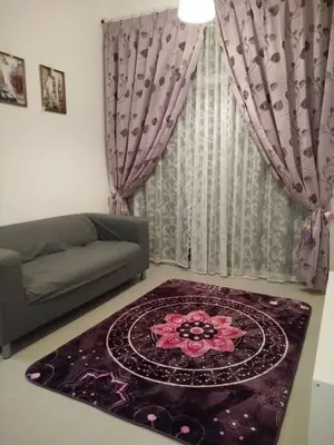 a living room with a couch and a rug at Casa D'One Homestay D Pasar Malam in Cameron Highlands