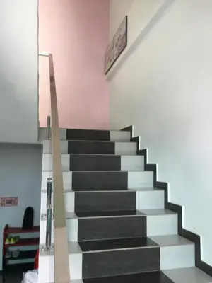 a staircase with black and white steps in a room at CK Homestay K.Sepetang in Taiping
