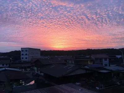 a sunset over a city with houses and buildings at CK Homestay K.Sepetang in Taiping