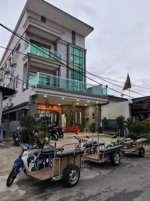 a group of motorcycles and trailers parked in front of a building at CK Homestay K.Sepetang in Taiping