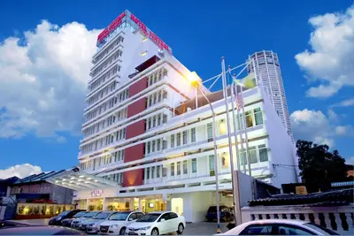 a building with cars parked in a parking lot at Hotel Sentral Georgetown @ City Centre in George Town