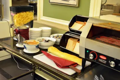 a counter with bread and a toaster oven with food at Hotel Sentral Georgetown @ City Centre in George Town