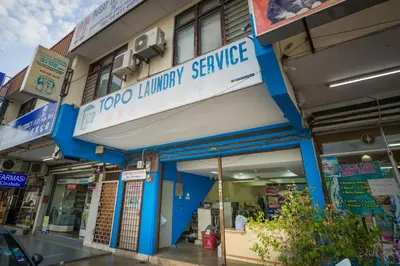a building with a sign for a grocery pharmacy service at Northern Lodge Hotel in Sungai Petani