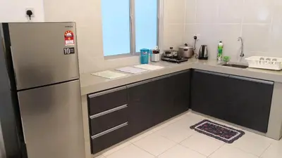 a kitchen with a stainless steel refrigerator and a window at My Home Apartment - The Quintet Condo in Cameron Highlands