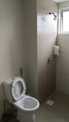 a bathroom with a white toilet and a shower at My Home Apartment - The Quintet Condo in Cameron Highlands