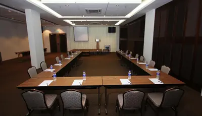 a conference room with tables and chairs with water bottles on them at Aroma Hotel in Butterworth