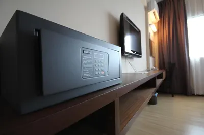 a flat screen tv sitting on top of a wooden table at Aroma Hotel in Butterworth