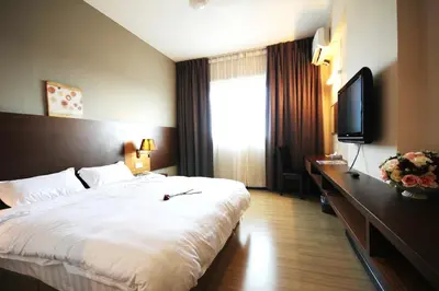 a hotel room with a bed and a television at Aroma Hotel in Butterworth