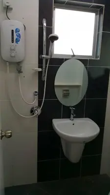 a bathroom with a toilet and a sink and a window at Ipoh EastEden Homestay in Ipoh