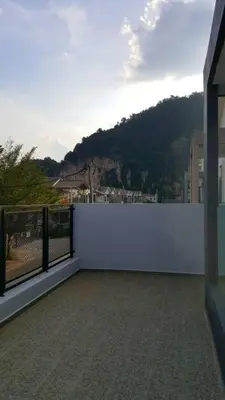 a white fence with a view of a mountain at Ipoh EastEden Homestay in Ipoh