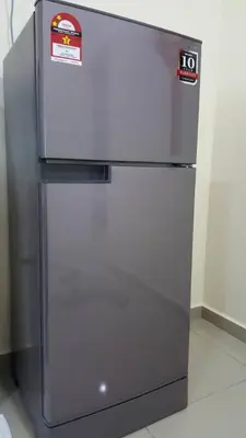 a stainless steel refrigerator with two stickers on it at Ipoh EastEden Homestay in Ipoh