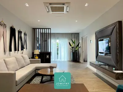 a living room with a couch and a tv at JOMSTAY Octagon Palm Suites Ipoh in Ipoh