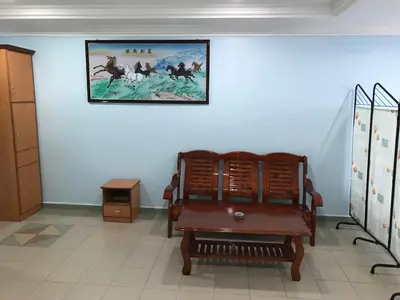 a room with a chair and a picture on the wall at Hotel Seri Kangsar KK Hotel in Kuala Kangsar