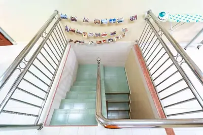 a staircase in a building with people on it at Star Light Homestay in Sitiawan