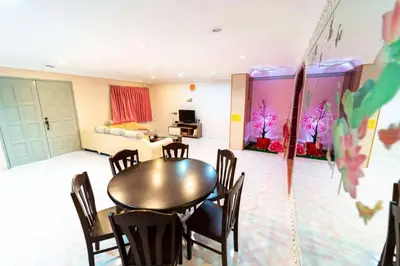 a dining room with a table and chairs in a room at Star Light Homestay in Sitiawan
