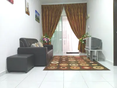 a living room with a couch and a rug at Wany Homestay & Guest House in Sungai Petani