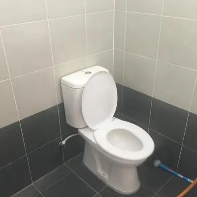 a bathroom with a white toilet in a room at Wany Homestay & Guest House in Sungai Petani