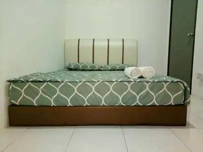 a bed with two towels on top of it at Wany Homestay & Guest House in Sungai Petani