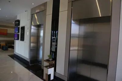 a lobby with a stainless steel refrigerator in a building at Rivertel in Teluk Intan