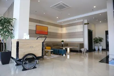 a lobby with a cart in the middle of a building at Rivertel in Teluk Intan