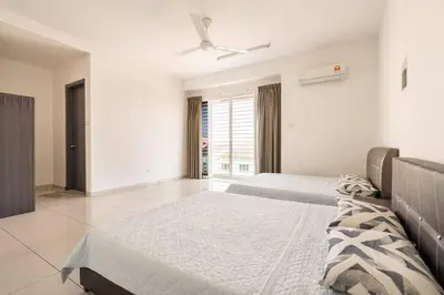 a bedroom with two beds and a ceiling fan at COCONUT HOMESTAY Tanjong Karang Sekinchan Kuala Selangor in Kampong Sungai Kajang