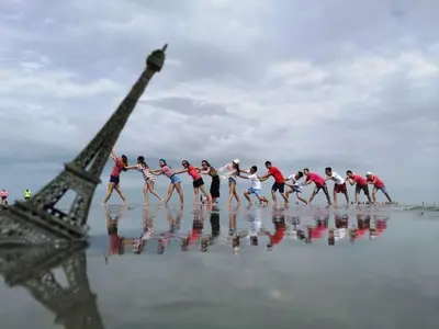 a group of people dancing in front of the eiffel tower at COCONUT HOMESTAY Tanjong Karang Sekinchan Kuala Selangor in Kampong Sungai Kajang