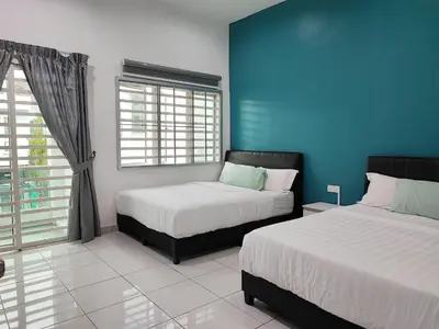 a bedroom with two beds and a blue wall at W21 atGoldenHills NightMarket WiFi 4R in Cameron Highlands