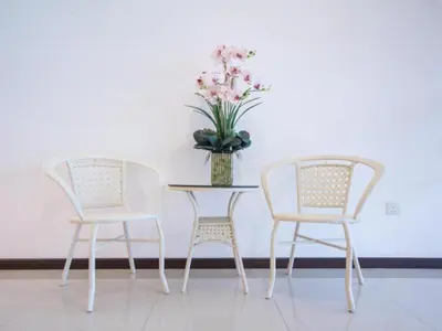 a table with two chairs and a vase of flowers at 118 Hotel Macalister in George Town
