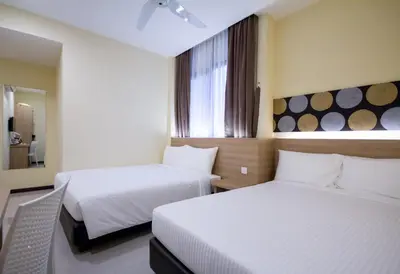 a hotel room with two beds and a window at 118 Hotel Macalister in George Town