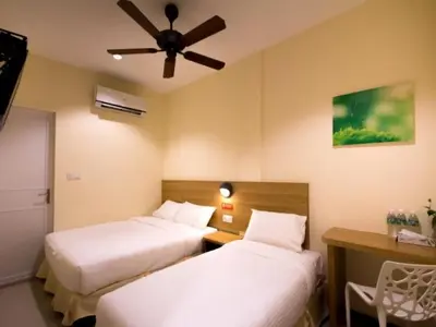 a hotel room with two beds and a ceiling fan at 118 Hotel,Dato Keramat - Self Check In in George Town