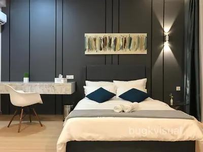 a bedroom with a large bed with blue pillows at Luxury Seaview Family Suite by Little Cabin in George Town