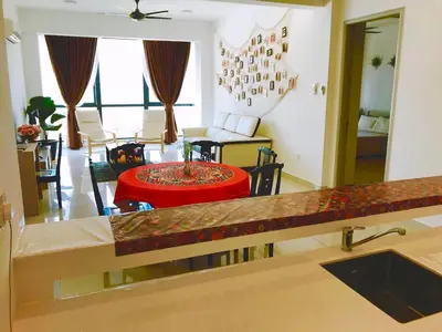 a kitchen and living room with a table and a couch at Luxury Seaview Family Suite by Little Cabin in George Town